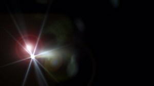 Abstract flicker glow optical lens flares light rotation animation flow from left to right on black background. 4K seamless loop dynamic kinetic bright star light rays effect. Star light streaks. | Premium Stock Video Footage
