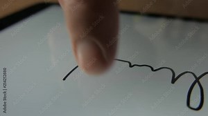 E-signature. Man is writing his signature directly on tablet with finger.