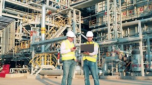 Oilfield engineers are talking at the oil-processing factory