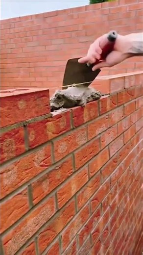 Brick aligned true, string guides precision in masonry