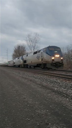 Amtrak #48 the Lake Shore Limited flies through a crossing with #124 #59 and an extra coach! 33126