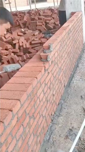 building high red brick walls using mortar and tools for professional construction house projects