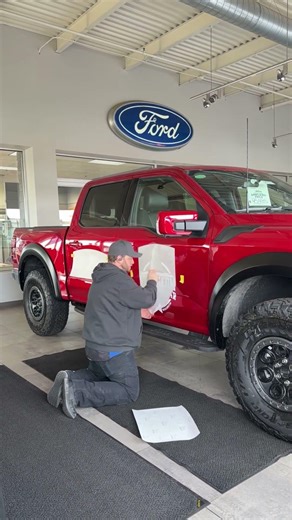 Team Holiday is installing custom graphics on this Ford F-150 Raptor.