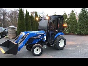 New Holland Boomer 24 tractor working