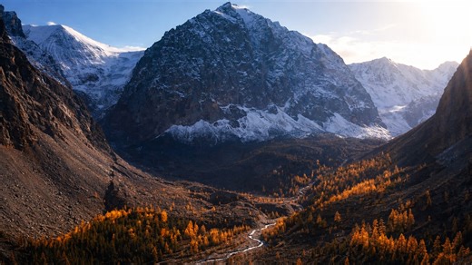 A valley hidden beneath giant peaks