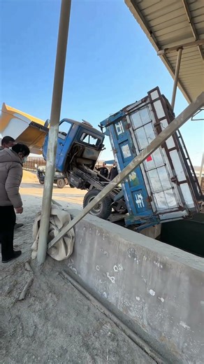 Watch A Loader Rescue A Dump Truck That Slid Into An Underground Corn Feeding Pit