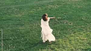 woman dances gracefully in an outdoor setting, her movements blending effortlessly with the natural surroundings. This video captures the harmony between freedom of movement and the serenity