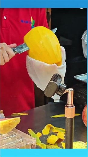 Peeling and splitting a fresh mango with care.