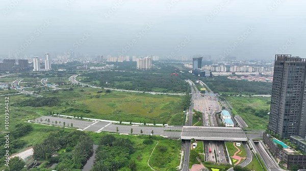 A paraplane flying over green parks and roads in ho chi minh city on a hazy day, aerial view