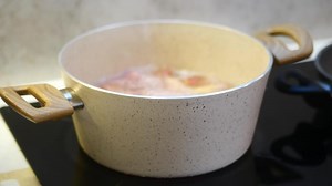 Download Cooking stew with fresh ingredients on the stove for free