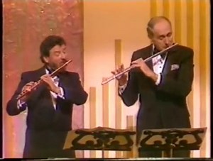 1.5K views · 136 reactions | On this day in 1984, Hank crossed the pond for his third and final Royal Command performance for Queen Elizabeth II. Hank conducted a piece with Irish musician, James Galway, on lead piccolo and the pair performed a flute duet. Watch the duo’s royal performance now: https://found.ee/ManciniRoyalCommand3 | Henry Mancini | Facebook
