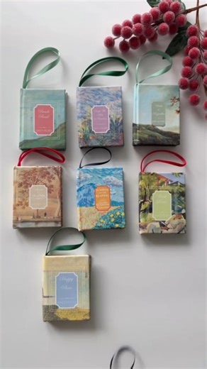 Diy With Love on Instagram: "Comment TUTORIAL to learn how to make these! Which is your favorite? I made these cute mini book Christmas ornaments with printable canvas! I recently shared a viral mini book ornament reel where I used my cricut to cut foil designs onto ornaments. However a lot of you don’t have access to a cricut so this is a fun and easy alternative way to cover your mini ornaments! All you need is a printer and some printable canvas. I based these off of some of the books I rebou