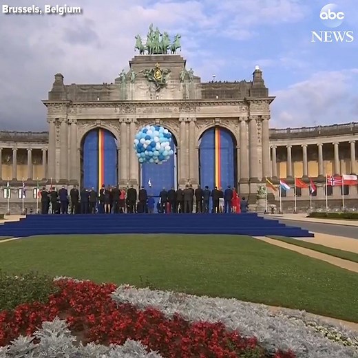 Saxophonists in bowler hats play while an aerial dancer is suspended by balloons in a noteworthy performance at the NATO opening ceremony. https://abcn.ws/2ucEpKN | ABC News