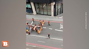 An angry London bystander ripped banners from Just Stop Oil climate activists and pushed some members around. The group had been marching slowly to hold up traffic. | Breitbart