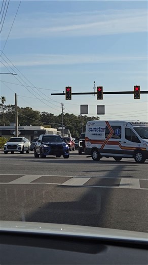BMW X5M Competition in dark blue color behind Sunstar Ambulance EMS Emergency Van Largo Florida