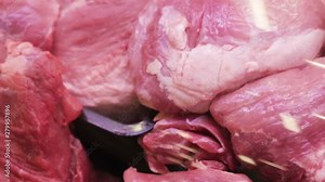 Fresh Raw Meat Tags in trays in a counter of market . Butcher shop. Pieces of freshly cut beef or pork meat on the showcase, close up view