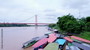 Explore the river coast with native boats and the Continental Bridge in this aerial shothot