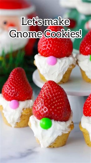 Easy Christmas Gnome Cookies are super cute and simple, made with store bought cookie dough, topped with a homemade buttercream “beard”, strawberry hat and candy nose.Comment CUTE & I’ll send ya the recipe.#gnomecookies https://www.momlovesbaking.com/easy-christmas-gnome-cookies/ | Mom Loves Baking
