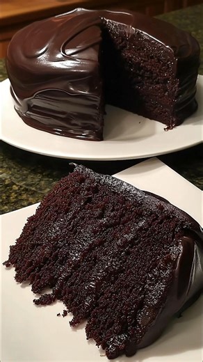 Dark Silk Chocolate Cake Ultra-moist dark chocolate cake drenched in smooth ganache. Pure chocolate bliss. Ingredients: 1 3/4 cups flour 3/4 cup cocoa powder (dark preferred) 1 1/2 cups sugar 1 1/2 tsp baking soda 1 tsp baking powder 1/2 tsp salt 2 eggs 1 cup buttermilk 1/2 cup oil 1 tsp vanilla 1 cup hot coffee or hot water Ganache: 2 cups dark chocolate 1 cup hot heavy cream Method: I whisked all the dry ingredients together, then added the eggs, buttermilk, oil, and vanilla until smooth. The