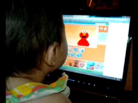 Baby playing an Elmo game on the computer