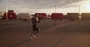 Athletic woman running in city in morning