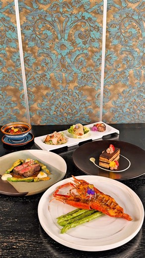 Seven moments, one graceful journey - our Set Dinner unfolds like a story told through taste and texture. It begins with the crisp elegance of Fried Tiger Prawn Netted Spring Rolls and the refreshing Herbals Salmon Salad, then flows into the comforting warmth of Chicken and Vegetables Soup. Each transition deepens - from the delicate sweetness of Golden River Prawn to the smoky richness of Grilled Iberico Pork and Wagyu Beef Wrapped in Betel Leaves. Finally, the evening closes with an Opera Cake