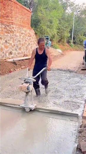 Leveling Fresh Concrete Surface Using a Power Screed Machine for Smooth Pavement Finish