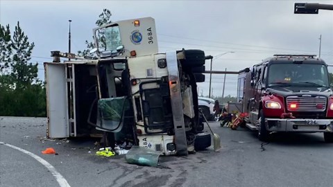 Minor injuries reported after garbage truck overturns