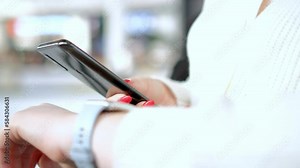 Smart watch on woman's hand . Woman's hand touching a smartwatch. Female's hand uses of wearable smart watch with smartphone. Stock Video