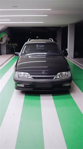Sleek Black Sedan Showcase in Modern Parking Garage