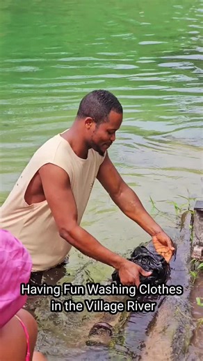 Enjoying a Fun Day Washing Clothes in the Village River