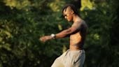 Muscular black african man workout exercising in a park