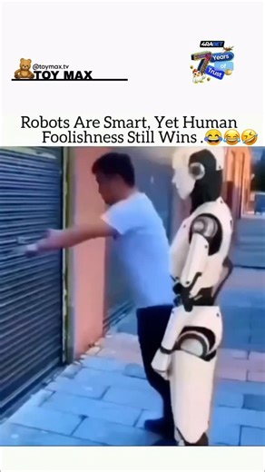 TOY MAX 🧸 | This 14-second clip captures a surprisingly funny moment between a human and a humanoid robot in an urban alleyway. A man wearing a blue... | Instagram