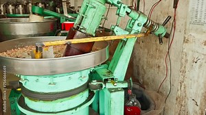Industrial meat grinder processing raw meat in a food production facility