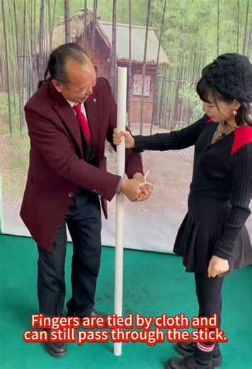 Fingers are tied by cloth and can still pass through the stick. #magic