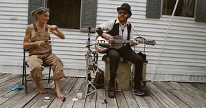 Spoon lady joins guitar player for bluegrass jam