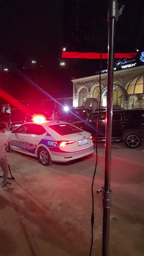 Nighttime Street Gathering Outside a Restaurant