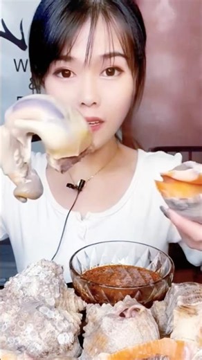 Steamed sea snails in coconut water with fish sauce