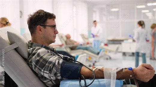 Male patient donating blood in a modern hospital clinic