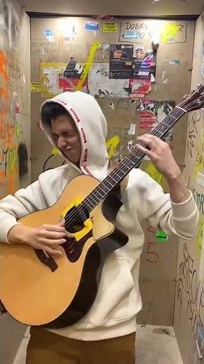 Marcin playing guitar in a messy elevator (Clip)