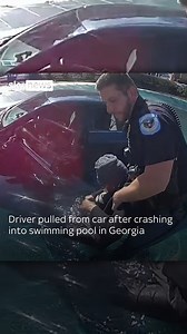 A driver has been pulled from a car after crashing into a swimming pool in Georgia. The officer had to smash one of the car's windows to get to the unresponsive driver, before pulling her out of the water | Sky News