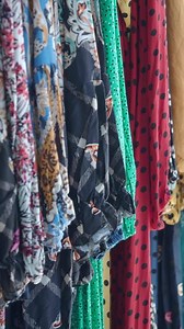 Download Colorful fabric display in a vibrant market setting for free