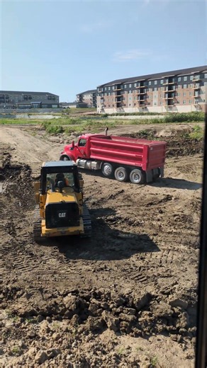Track loader leveling a pad for a foundation.