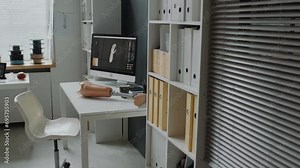 Rehabilitation center in light colours with display showing modern software which helping creating prosthetics for people with disabilityRehabilitation center in light colours with display showing mod
