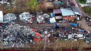 Waste disposal landfill with trucks unloading the wastes on it. Aerial view.
