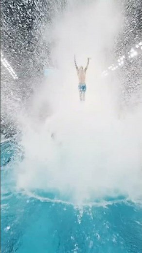 a man jumping in a swimming pool