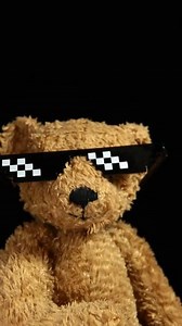 Download a teddy bear wearing sunglasses and a black background for free