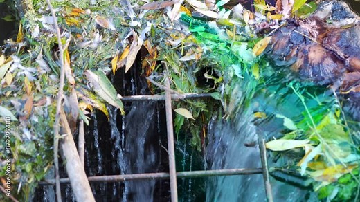 Pollution with garbage floating in a water stream in 4k slow motion 60fps