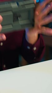 Vertical Tech content creator filming technology review of V mount battery, unpacking it and presenting specifications to audience, close up. Influencer showing charging device to subscribers, camera A