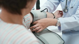 Download Close Up Doctor Checking Patient's Blood Pressure for free